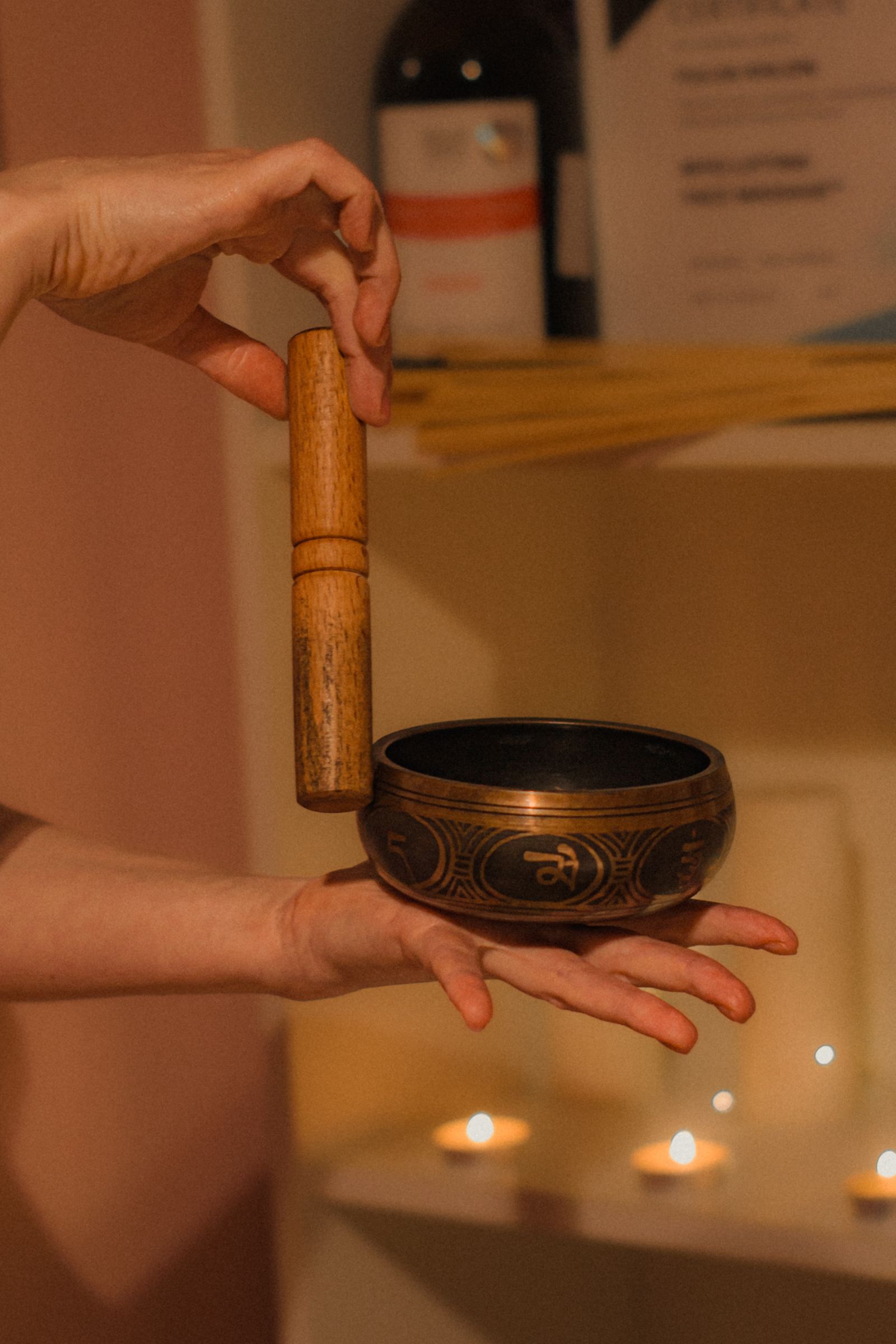 Hands playing a Tibetan singing bowl